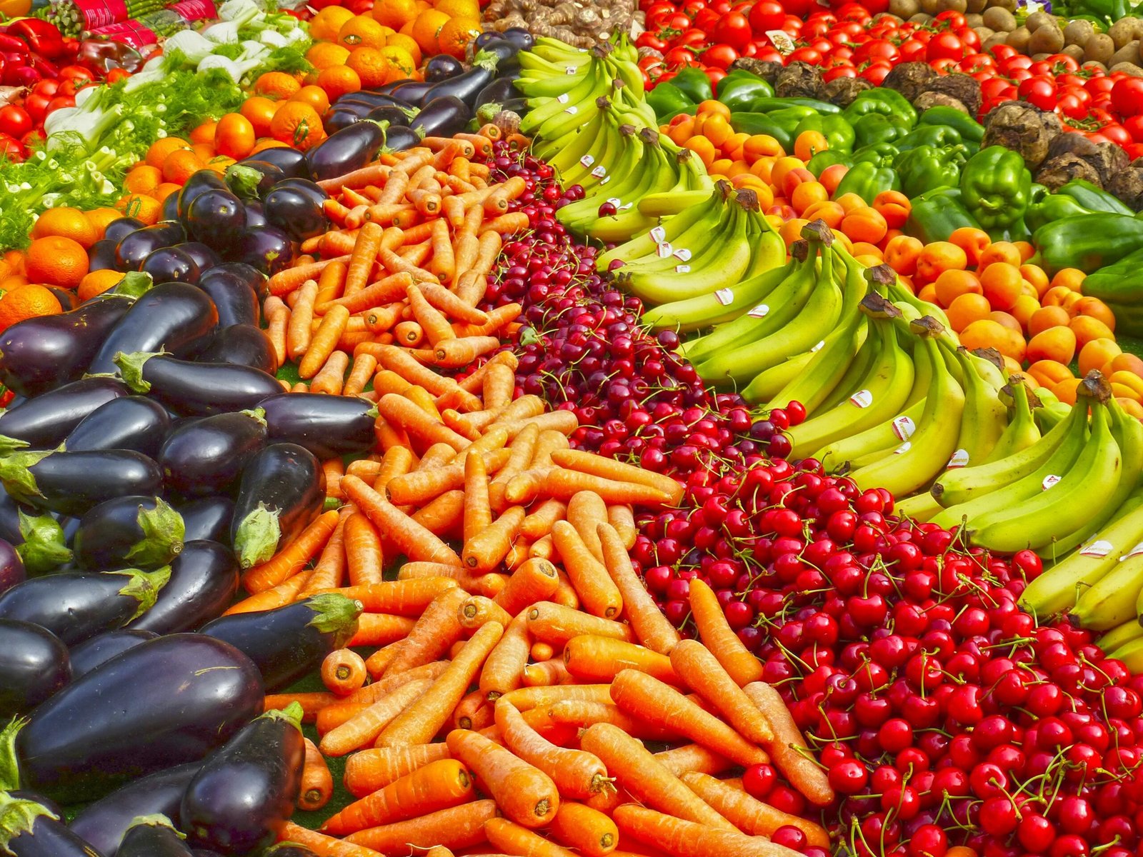 Vibrant selection of fresh fruits and vegetables on a market stall. Healthy eating and organic living.